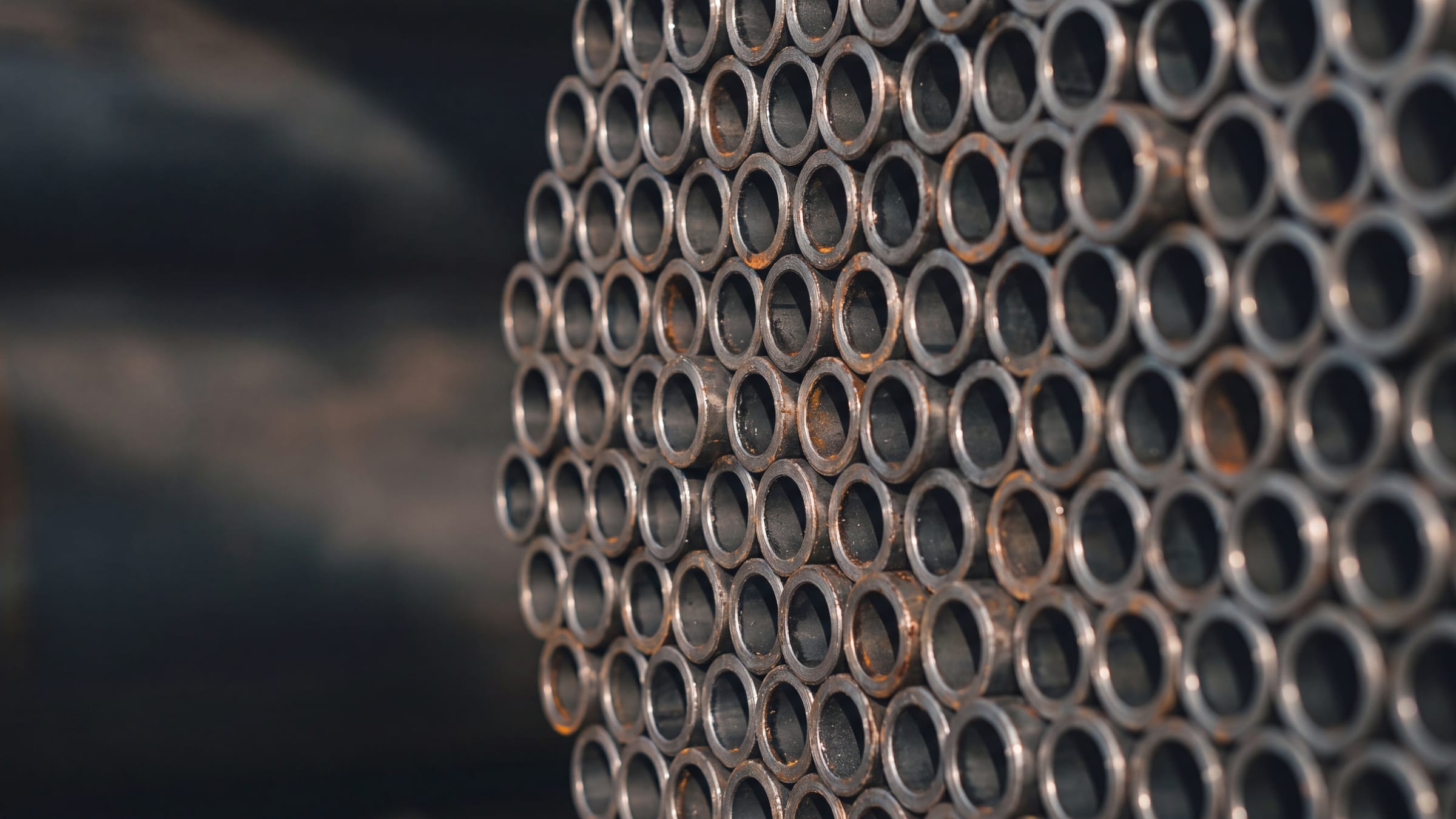 Close-up of stacked steel pipes